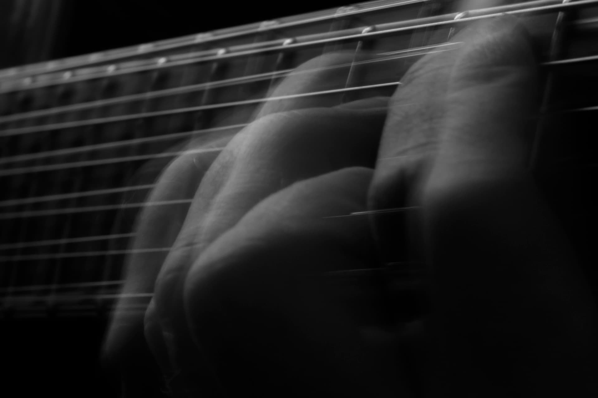 Motion blur of fingers on guitar strings